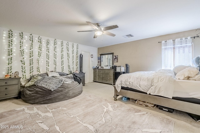 carpeted bedroom with ceiling fan and visible vents