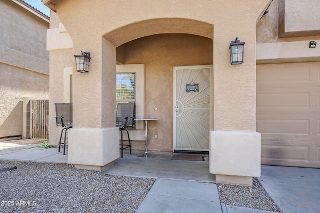 property entrance featuring stucco siding