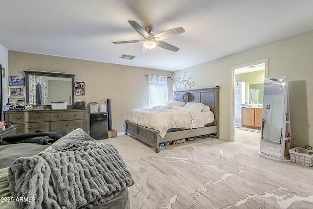bedroom with a ceiling fan, visible vents, and ensuite bath