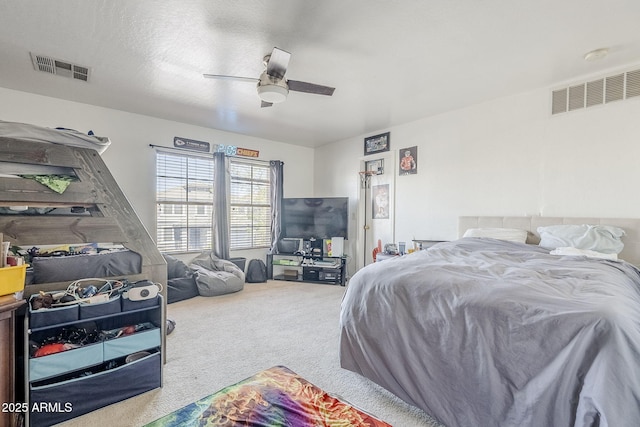 bedroom with carpet floors, ceiling fan, and visible vents