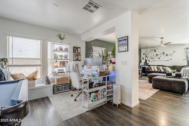 home office with baseboards, a ceiling fan, wood finished floors, and visible vents