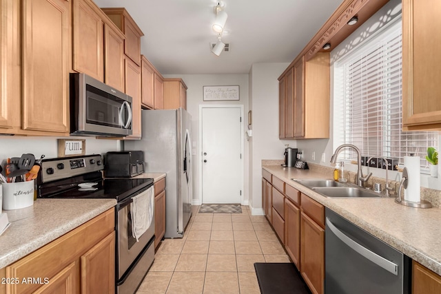 34913 N 30th Dr, Phoenix, AZ 85086 - kitchen with appliances with stainless steel finishes, a sink, light tile patterned floors, light countertops, and baseboards