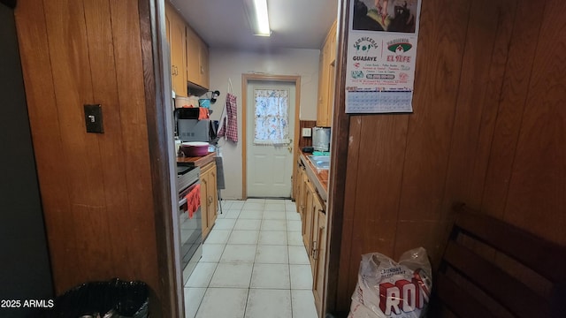 kitchen with stove and light tile patterned floors