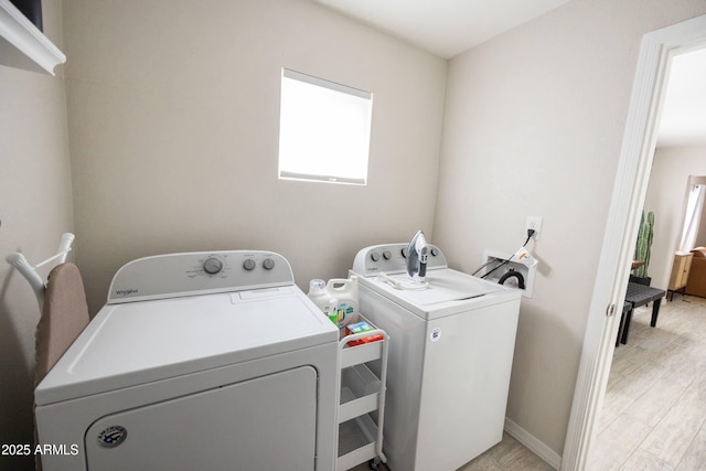 1513 E Sheridan St, Phoenix, AZ 85006 - laundry room featuring separate washer and dryer, light wood-style floors, and baseboards