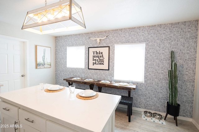 1513 E Sheridan St, Phoenix, AZ 85006 - kitchen featuring light wood-style flooring, light countertops, white cabinetry, and baseboards