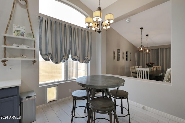 dining room featuring a notable chandelier and vaulted ceiling