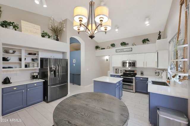 kitchen with blue cabinets, sink, a center island, stainless steel appliances, and white cabinets