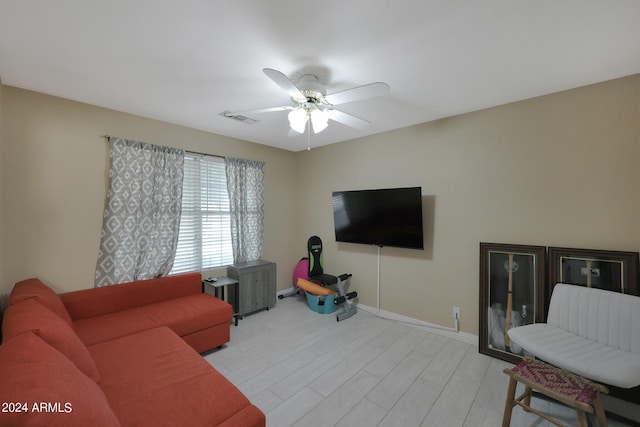 living room featuring ceiling fan and light hardwood / wood-style floors