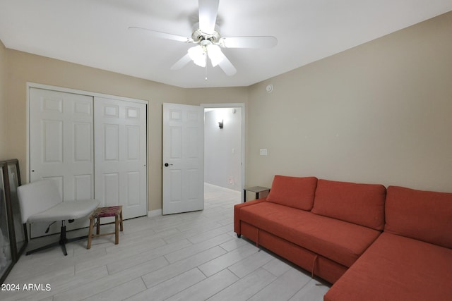 living room featuring ceiling fan and light hardwood / wood-style floors