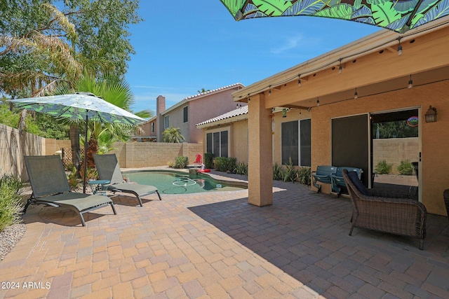 view of patio / terrace featuring a fenced in pool