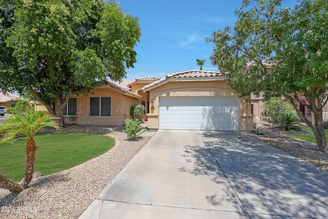 view of front of home with a garage and a front yard