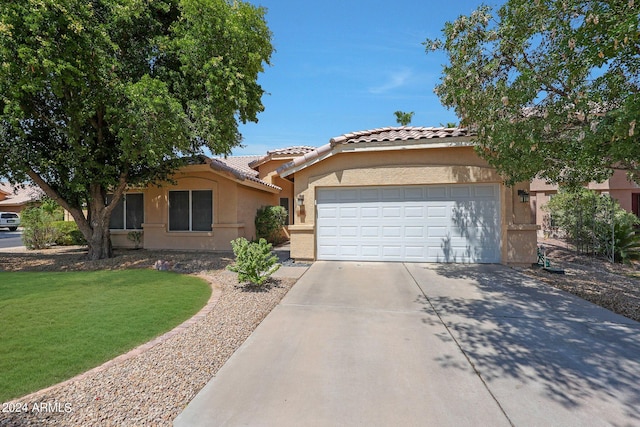 view of front of property featuring a garage and a front lawn