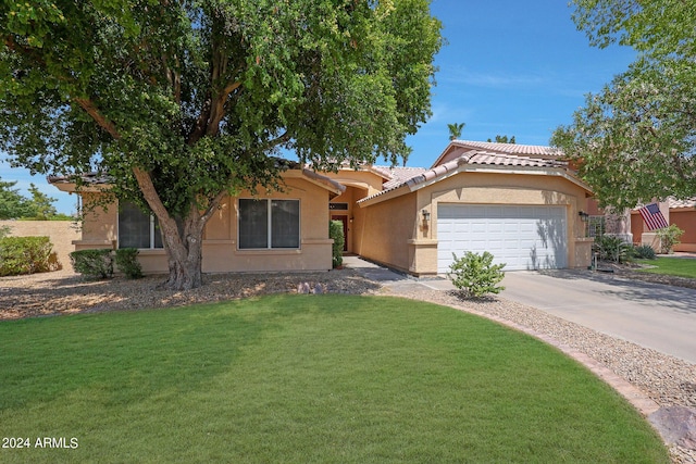 view of front facade with a garage and a front yard