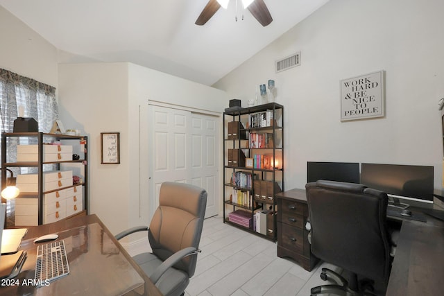 home office featuring light hardwood / wood-style flooring, vaulted ceiling, and ceiling fan