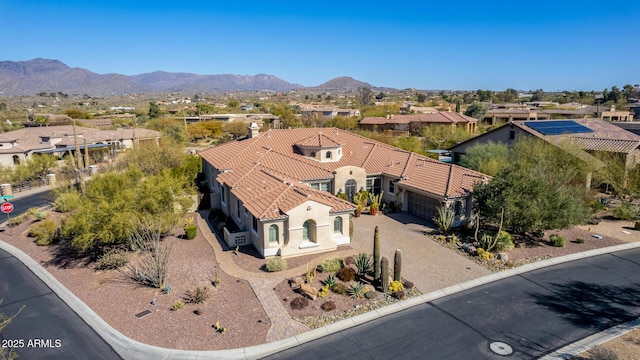 birds eye view of property with a mountain view