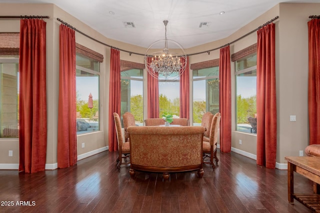 dining room featuring a notable chandelier and dark hardwood / wood-style flooring