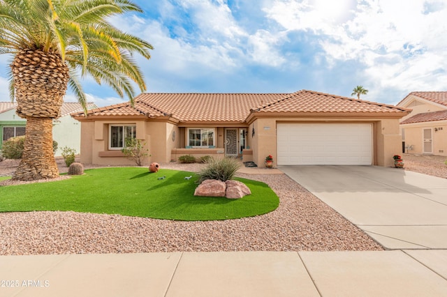 mediterranean / spanish house with a front lawn and a garage