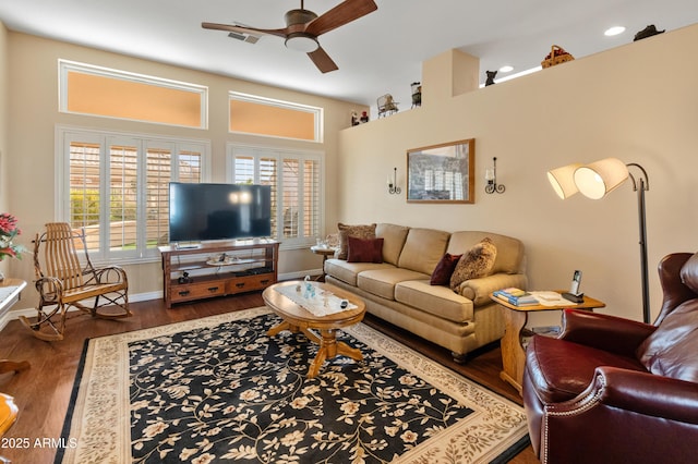 living room featuring ceiling fan and dark wood-type flooring