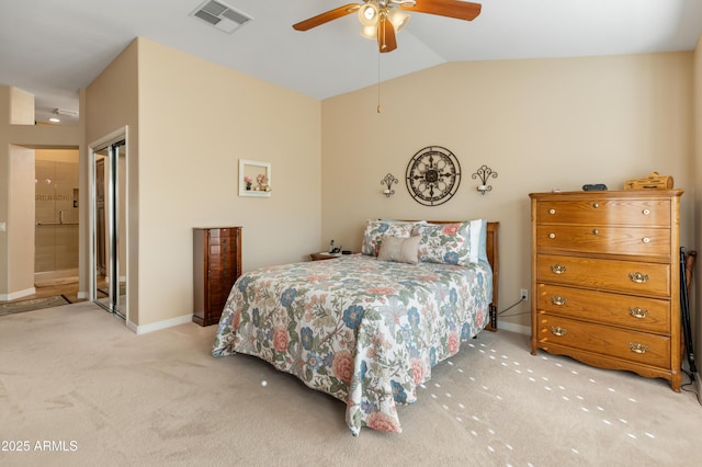 carpeted bedroom featuring connected bathroom, a closet, vaulted ceiling, and ceiling fan