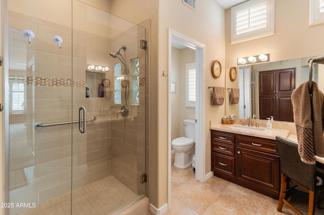 bathroom featuring walk in shower, tile patterned flooring, vanity, and toilet