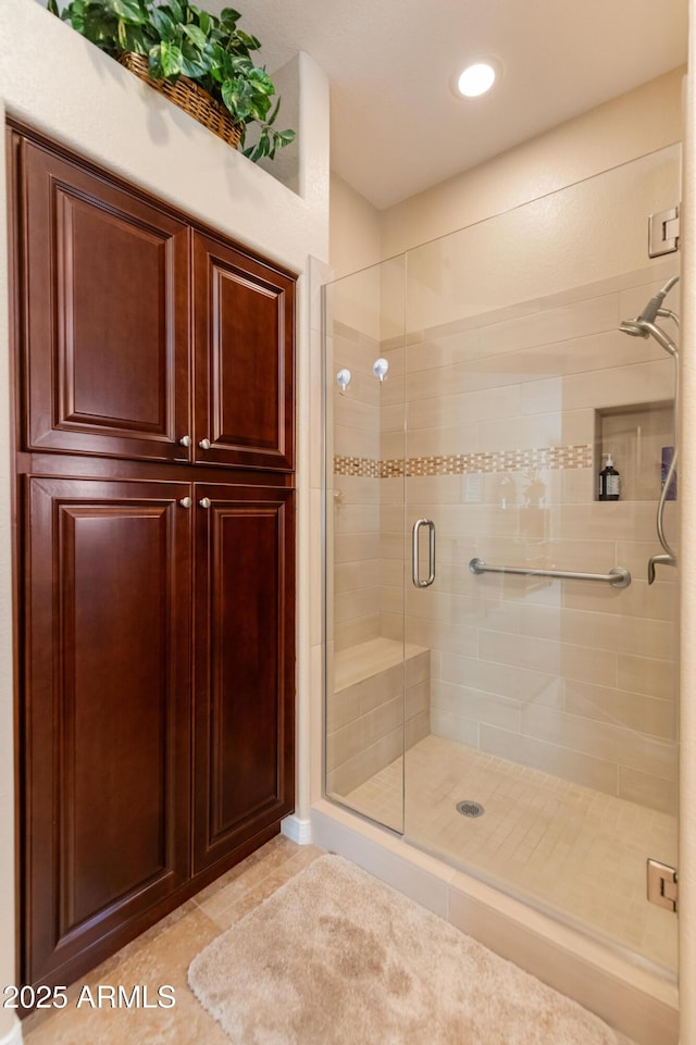 bathroom featuring tile patterned flooring and an enclosed shower