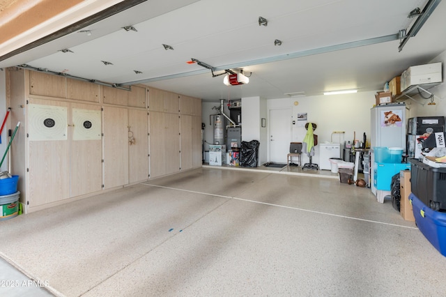 garage with a garage door opener and water heater