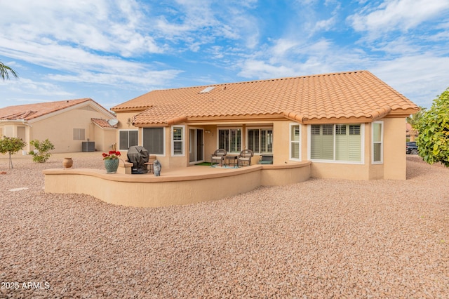 back of property featuring a patio area and central AC