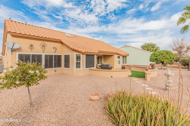 rear view of house with a patio area and central air condition unit