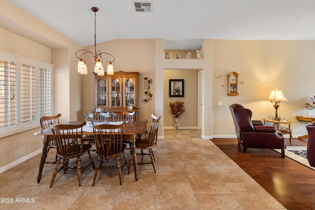 dining area featuring a chandelier and vaulted ceiling