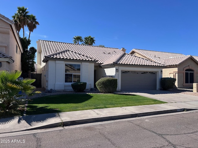 view of front of home featuring stucco siding, a tile roof, concrete driveway, a front yard, and a garage