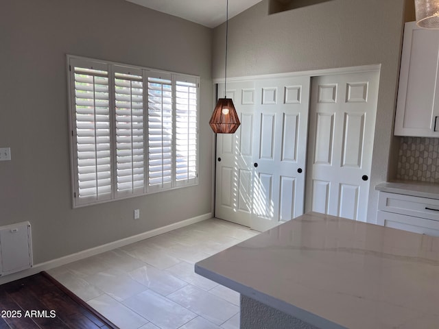 unfurnished dining area featuring baseboards