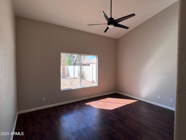 spare room with dark wood finished floors, lofted ceiling, baseboards, and ceiling fan