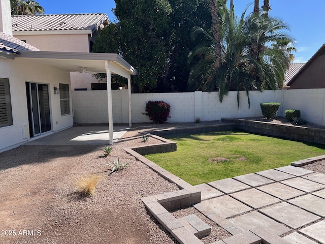 view of yard with a ceiling fan, a patio, and a fenced backyard