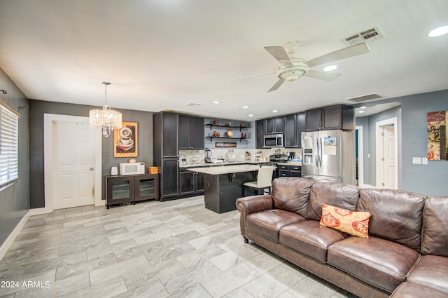 living room featuring ceiling fan with notable chandelier