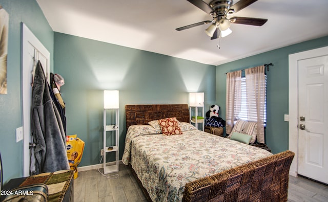 bedroom featuring hardwood / wood-style flooring and ceiling fan