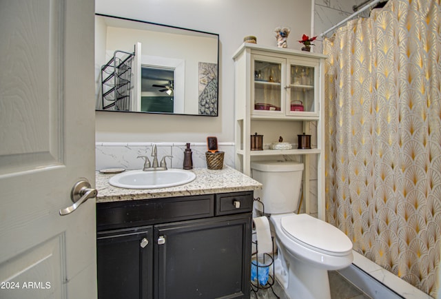 bathroom with a shower with shower curtain, tile patterned floors, vanity, and toilet