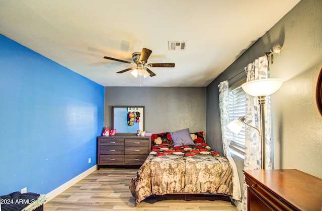 bedroom with light hardwood / wood-style floors and ceiling fan