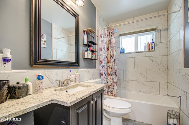 full bathroom with shower / bath combo with shower curtain, vanity, toilet, and tile walls