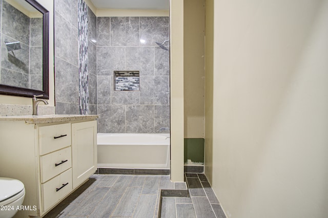 full bathroom with vanity, toilet, and tiled shower / bath combo