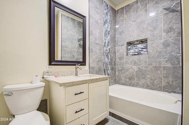 full bathroom featuring toilet, vanity, and tiled shower / bath