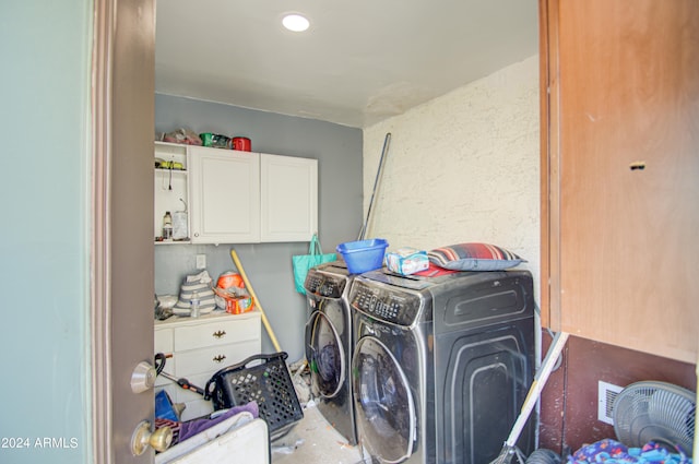 washroom with washing machine and dryer and cabinets