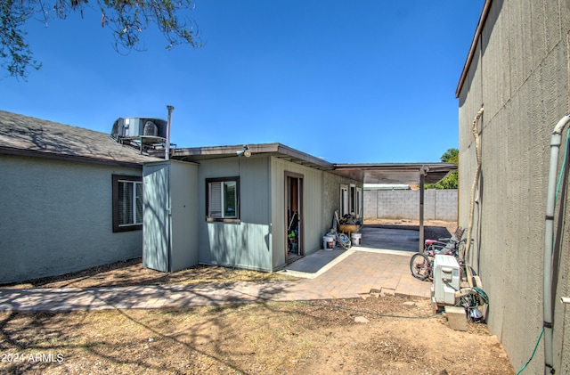 view of property exterior with cooling unit and a patio