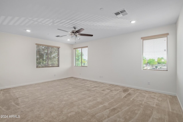 carpeted empty room featuring ceiling fan