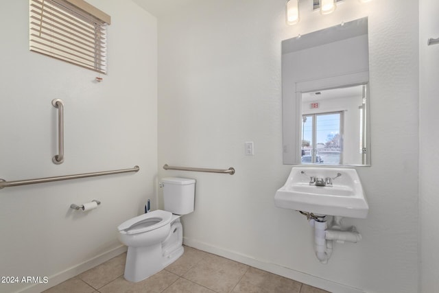 bathroom with tile patterned flooring, toilet, and sink