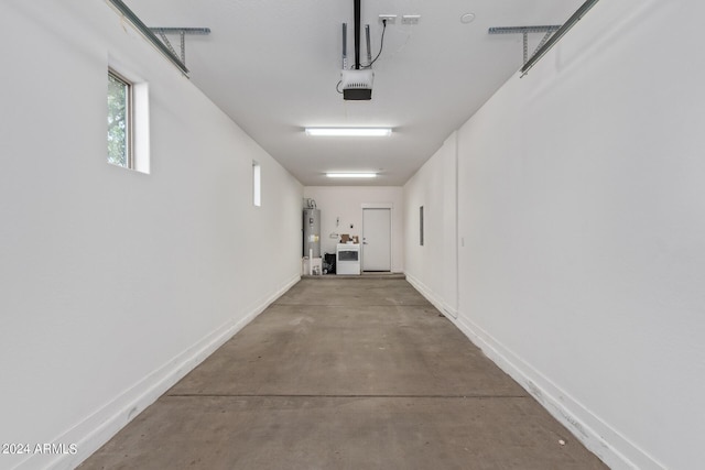 garage featuring a garage door opener and water heater