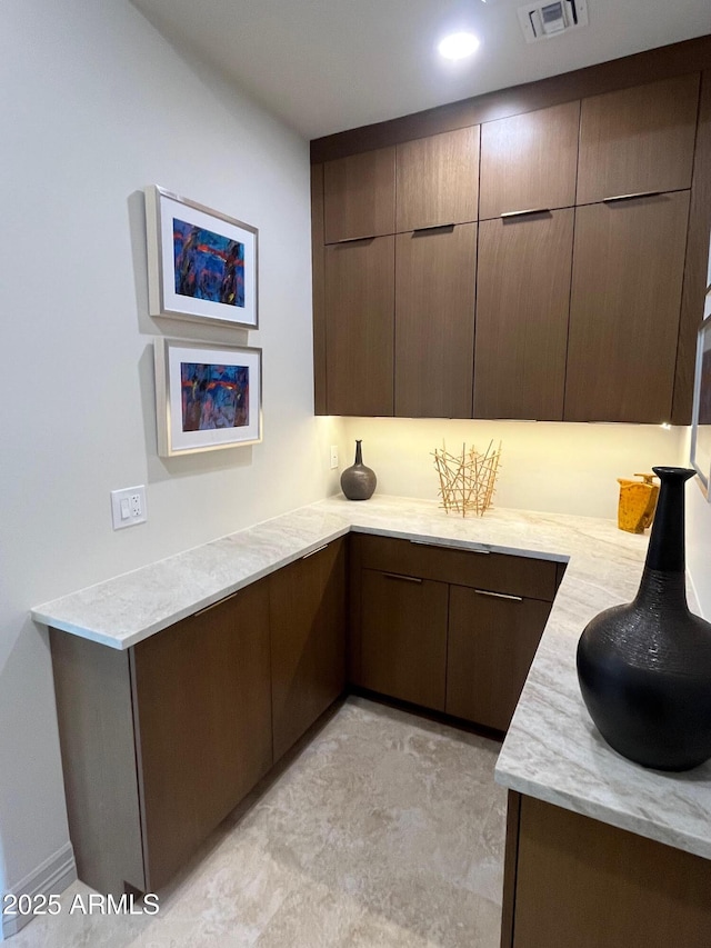 10821 E Troon N Dr, Scottsdale, AZ 85262 - kitchen with modern cabinets, dark brown cabinets, and light stone counters