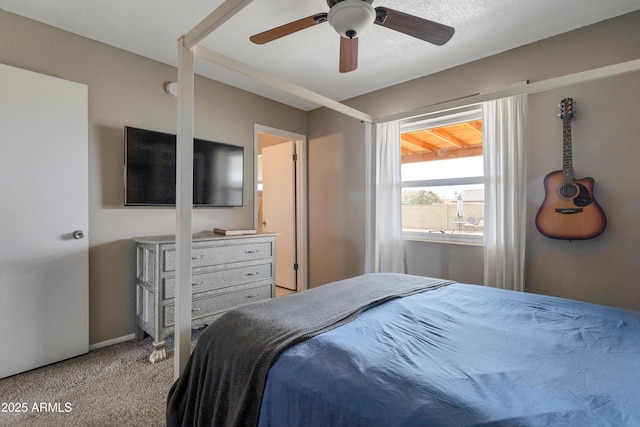 bedroom with light carpet, ceiling fan, and baseboards