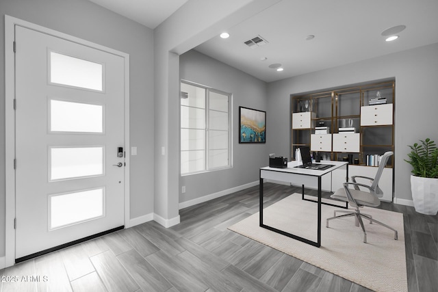 home office with baseboards, visible vents, a wealth of natural light, and wood finished floors