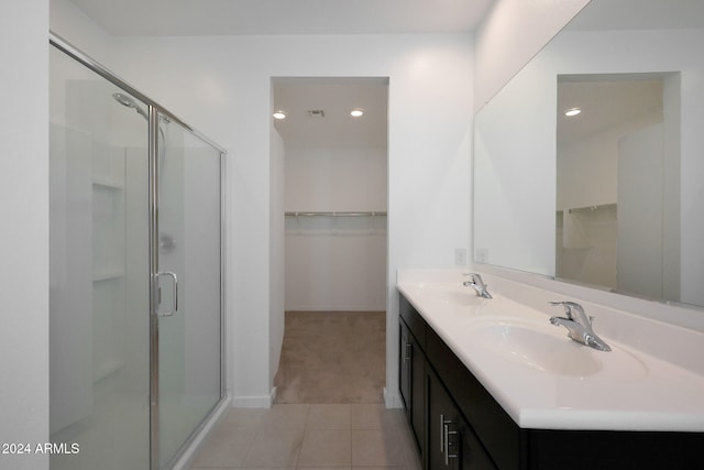 bathroom with tile patterned floors, vanity, and walk in shower