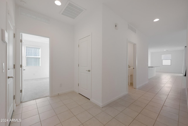 hall with light tile patterned flooring